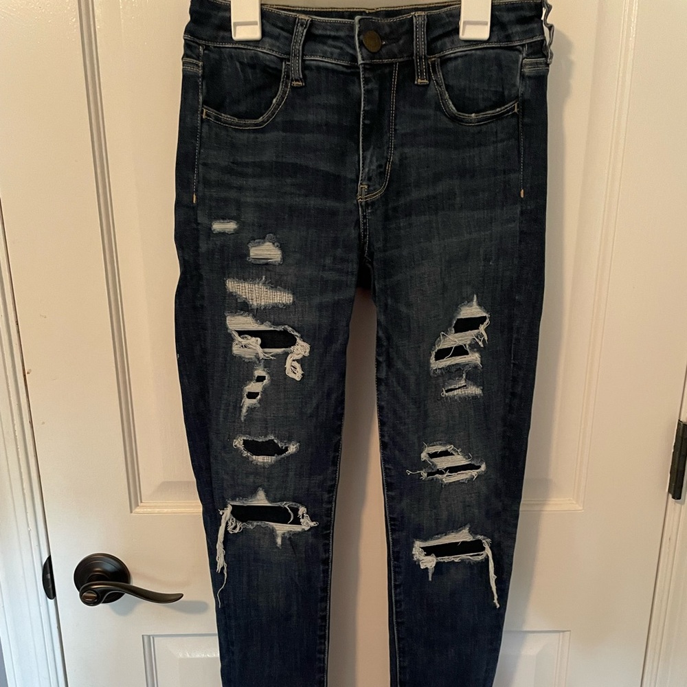 American eagle next level stretch blue jeans w rips and patches underneath